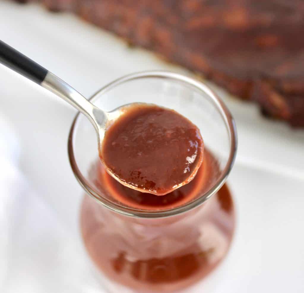 Keto Raspberry Chipotle BBQ Sauce in glass bowl with spoonful