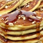 ricotta pancakes with syrup being poured over top