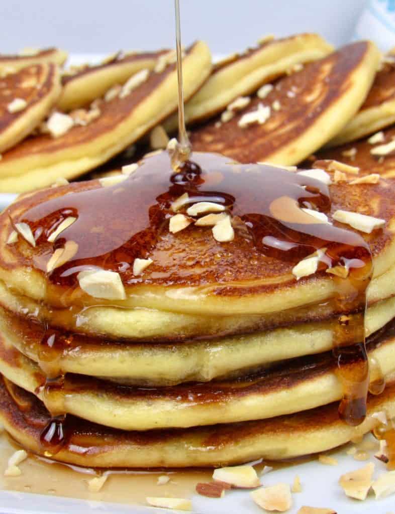 ricotta pancakes with syrup being poured over top