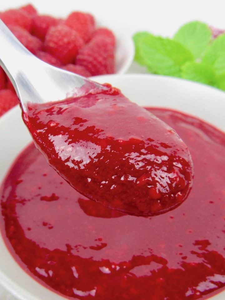 raspberry sauce being held up with spoon