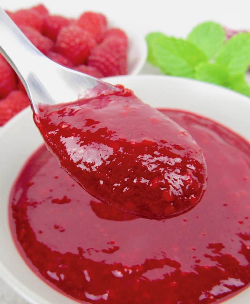 raspberry sauce being held up with spoon