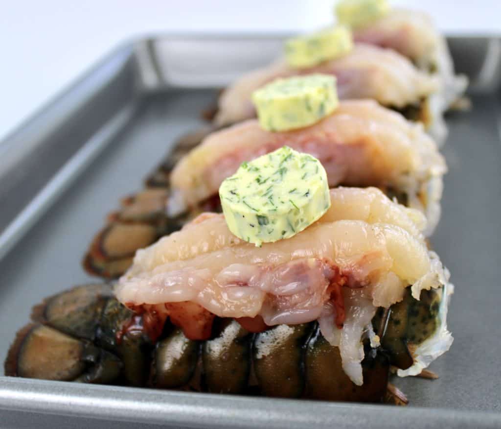 4 lobster tails with compound butter pads on top