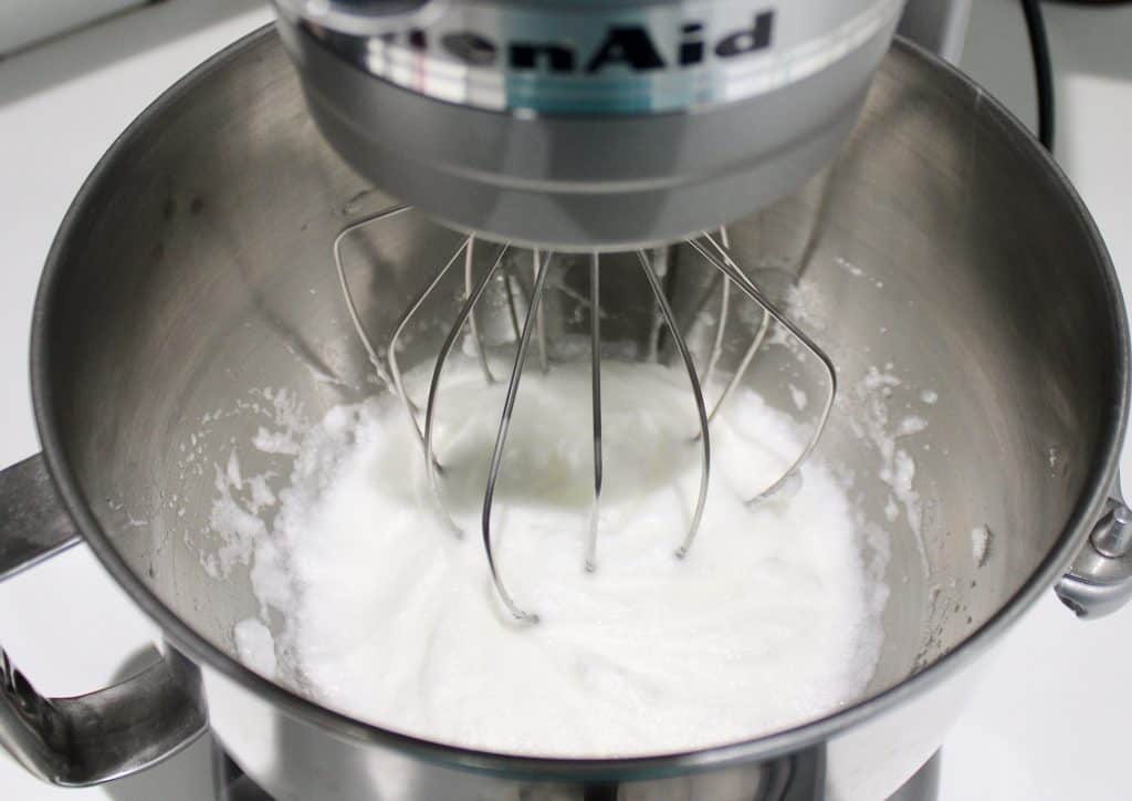 egg whites being whipped in stand mixer