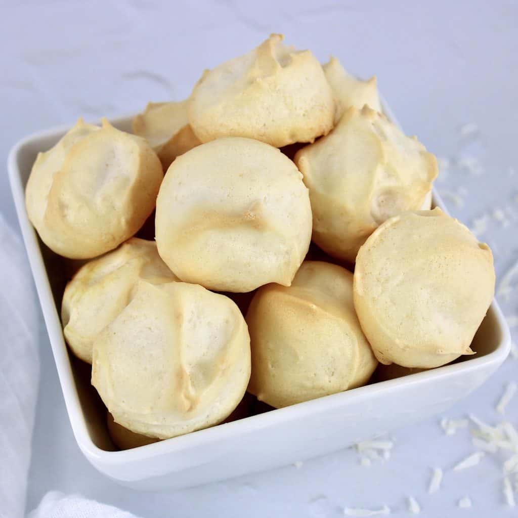 coconut meringue cookies piled up in white bowl
