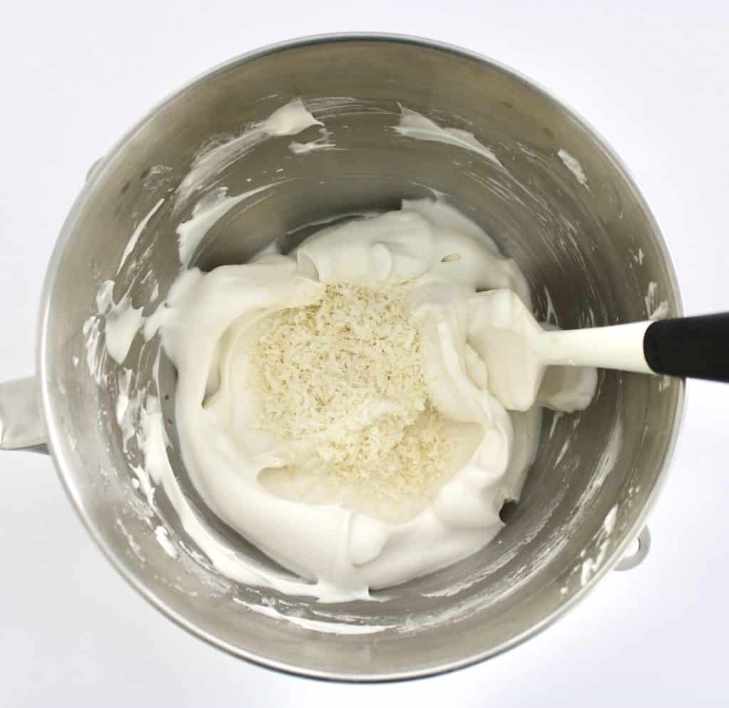 whipped egg whites in stand mixer and shredded coconut 