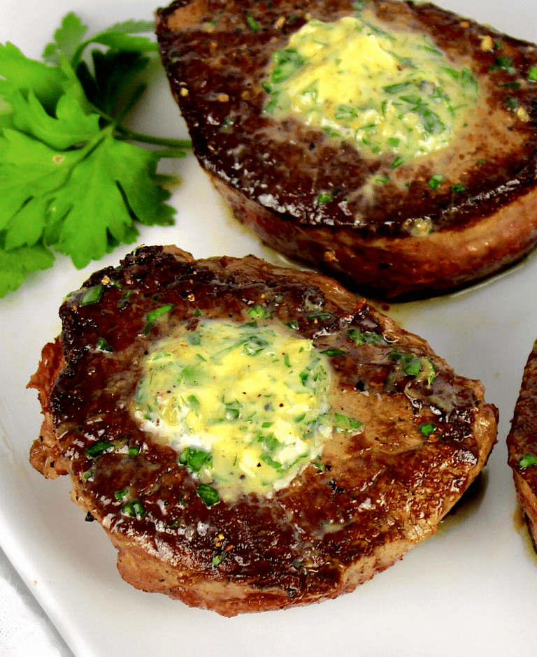 closeup of Pan-Seared Filet Mignon Pin with compound butter on top