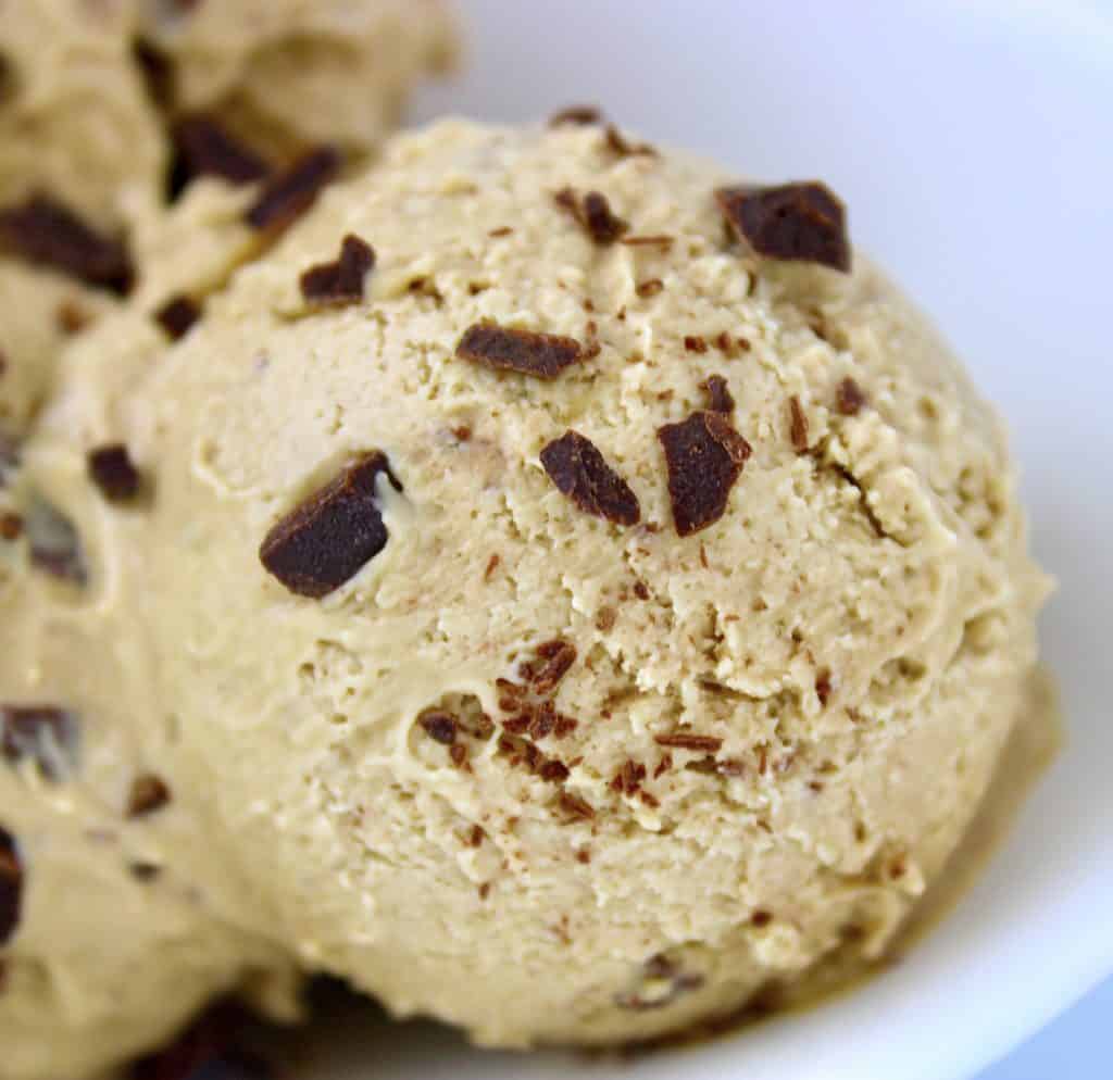closeup of a scoop of coffee chip ice cream in white bowl
