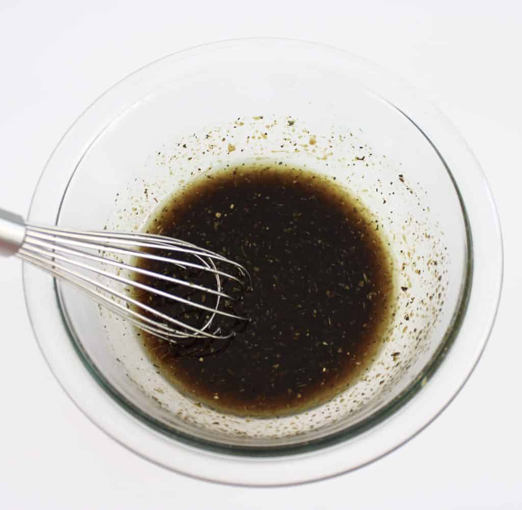 balsamic chicken marinade in glass bowl with whisk