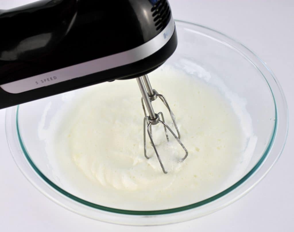 egg whites being mixed in hand mixer