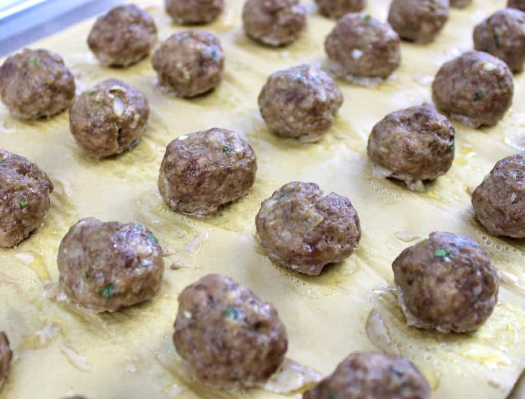 closeup of crockpot bbq meatballs baked on baking sheet