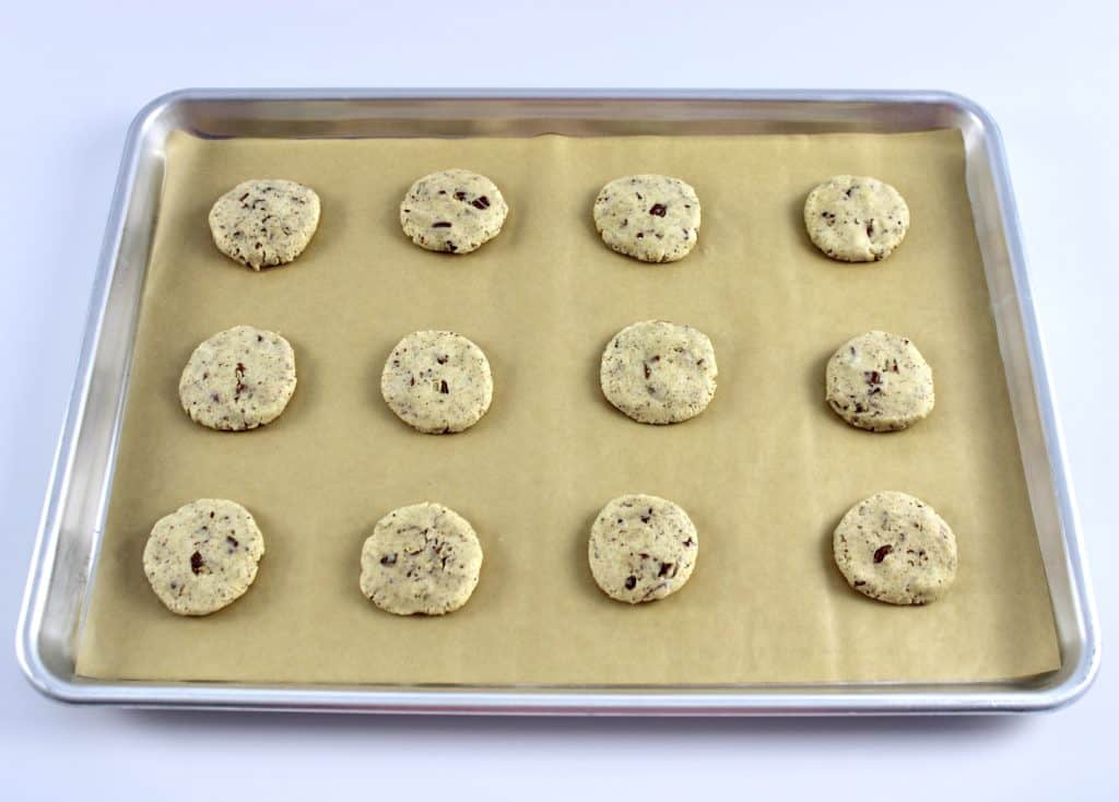 raw butter pecan cookie dough on baking sheet with parchment