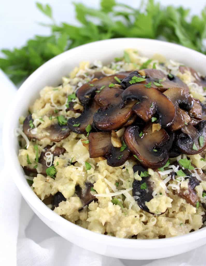 Keto Cauliflower Mushroom Risotto in white bowl with mushrooms on top