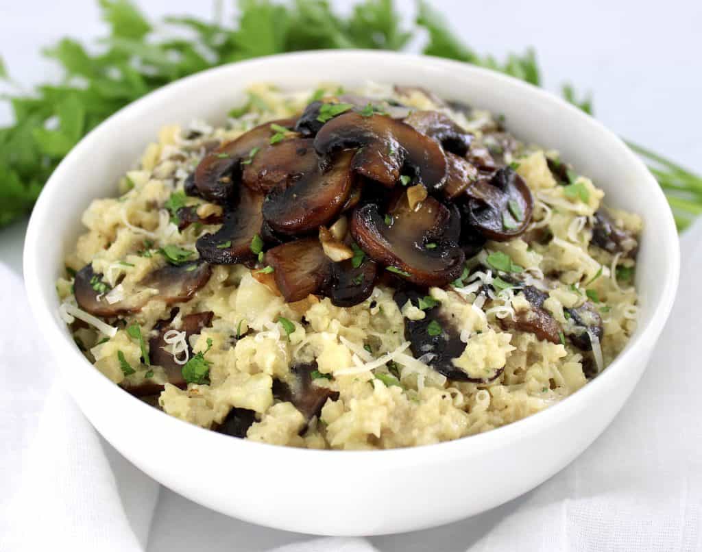 Keto Cauliflower Mushroom Risotto in white bowl with mushrooms on top
