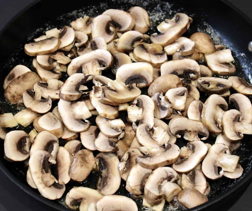 raw mushrooms in skillet