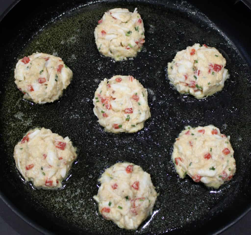 uncooked crab cakes in skillet