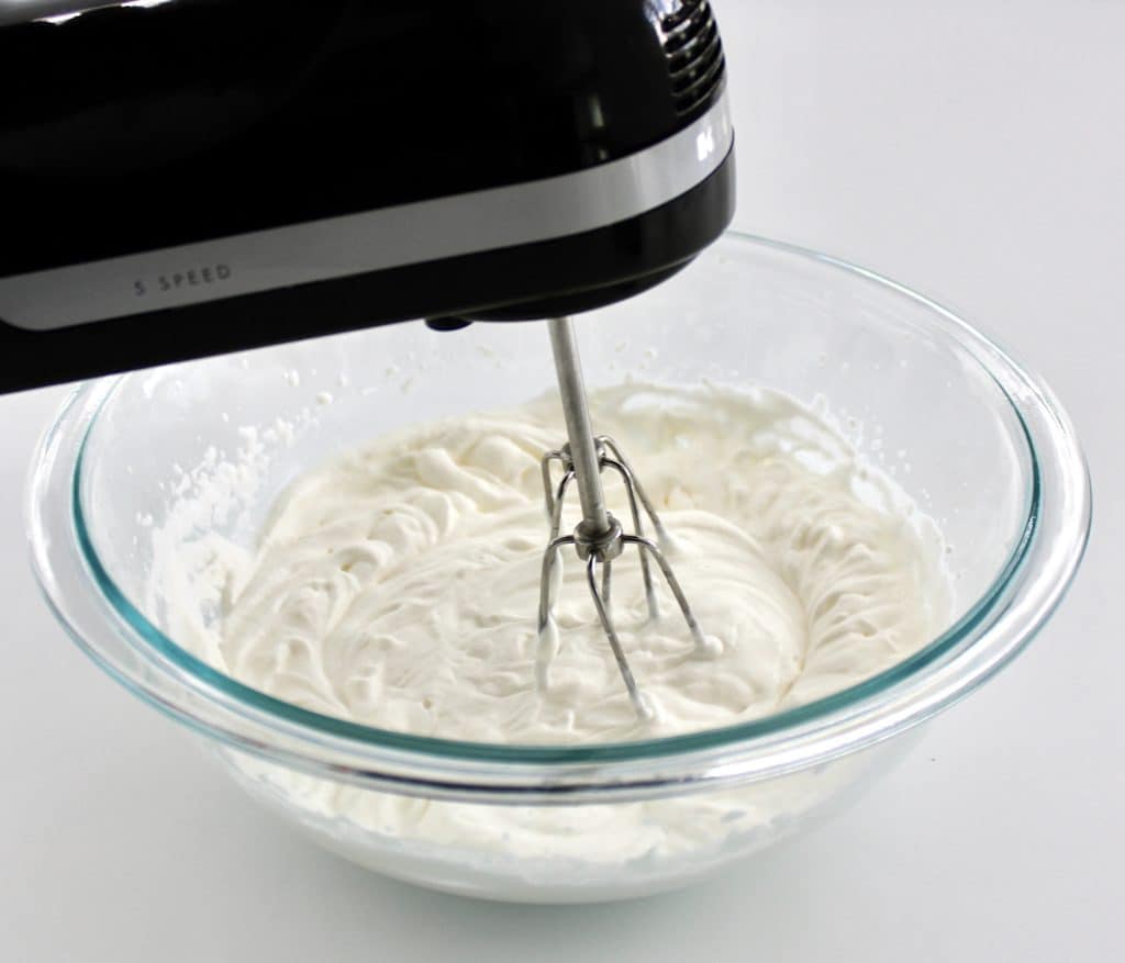 whip cream being mixed with hand mixer