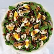Keto Spinach Salad with Hot Bacon Dressing in white bowl