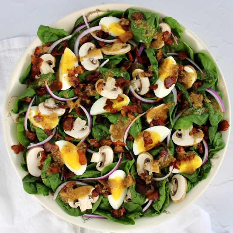 Keto Spinach Salad with Hot Bacon Dressing in white bowl