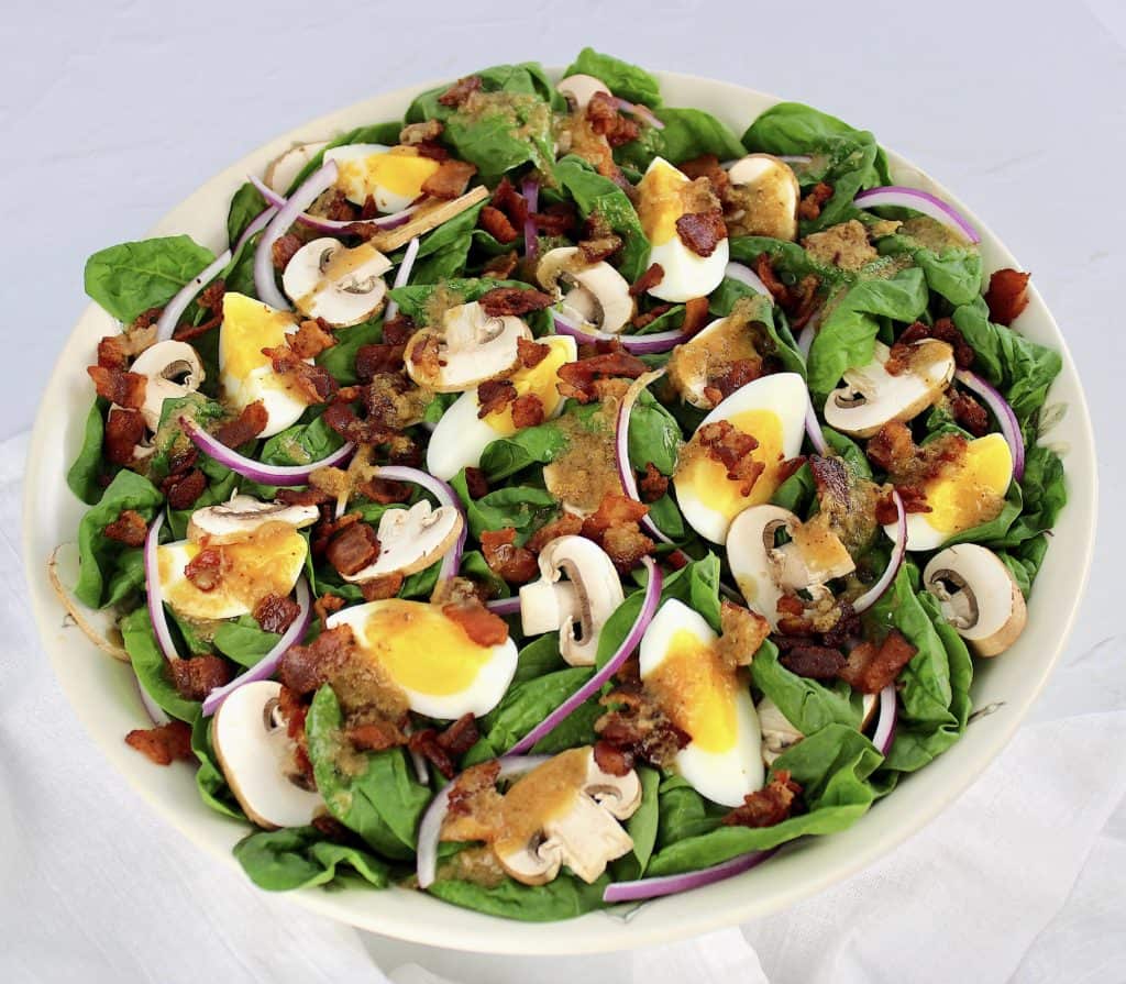 Keto Spinach Salad with Hot Bacon Dressing in white bowl
