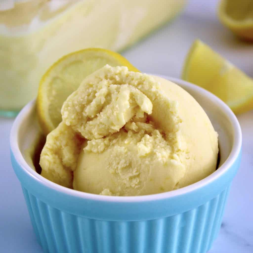 closeup of lemon ice cream in blue ramekin
