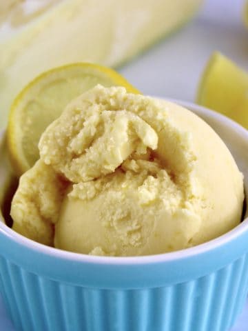 closeup of lemon ice cream in blue ramekin