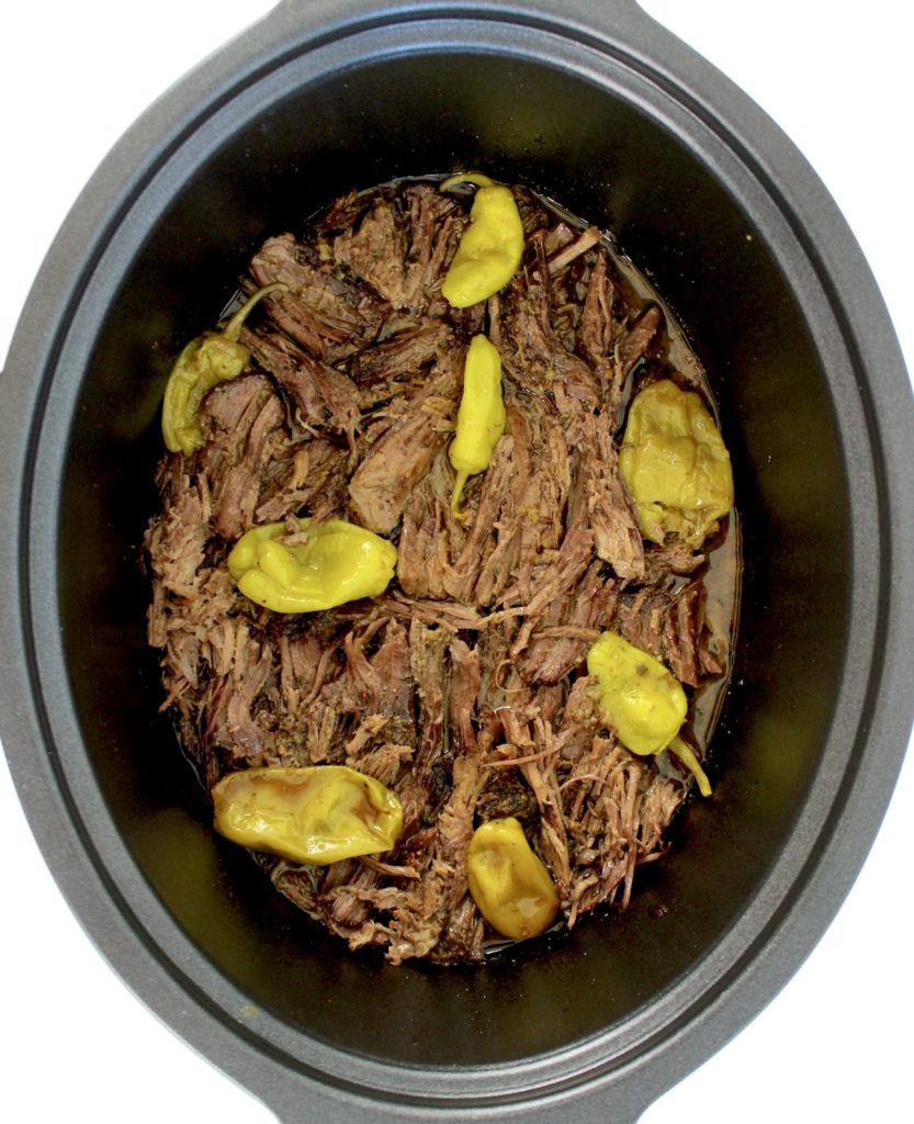 overhead view of mississippi pot roast in slow cooker insert