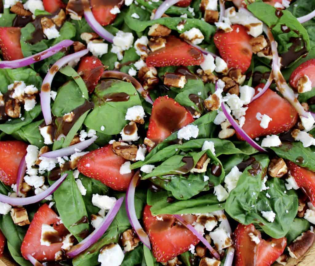 closeup of Strawberry Spinach Salad with Balsamic Vinaigrette on top