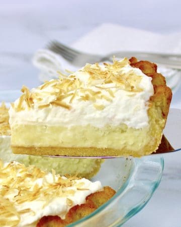 closeup of Coconut Cream Pie slice with pie in background