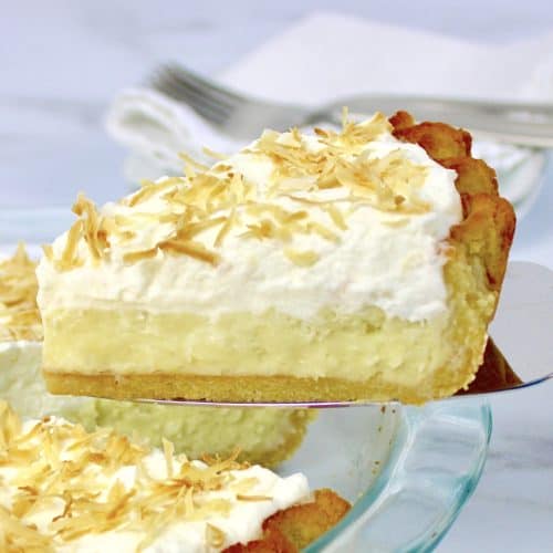 closeup of Coconut Cream Pie slice with pie in background