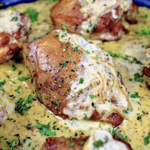 closeup of chicken dijon in skillet with sauce on top
