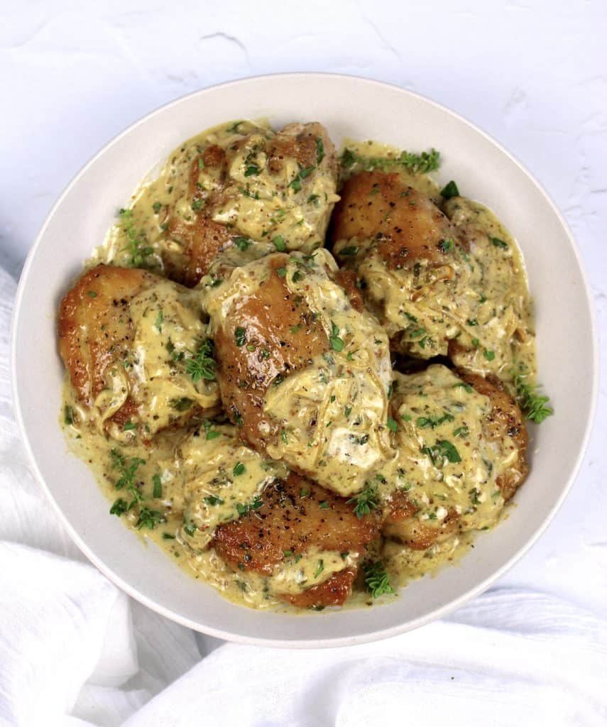 overhead view of Creamy Dijon Chicken Thighs on white plate