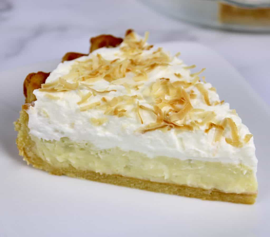 slice of coconut cream pie on white plate