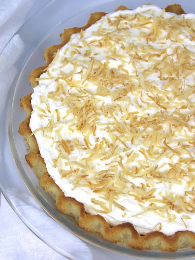 coconut cream pie with toasted coconut over the top