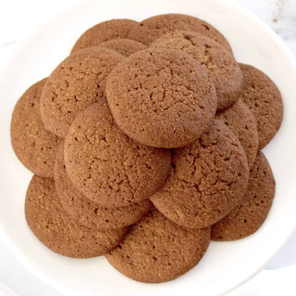 gingerbread cookies piled up on white plate