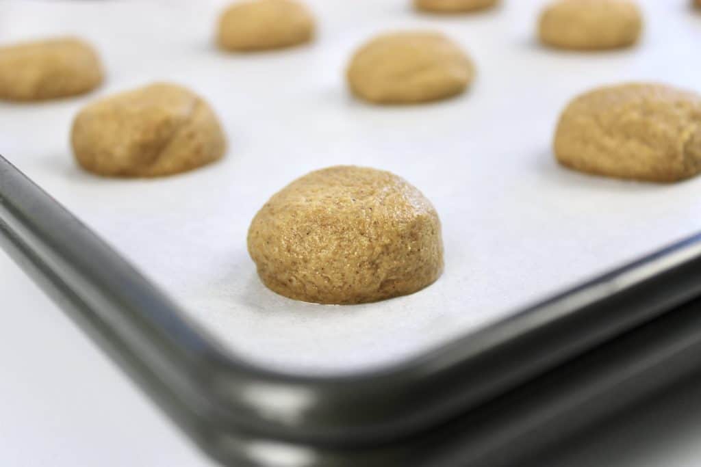 gingerbread cookie dough balls on 2 baking sheets