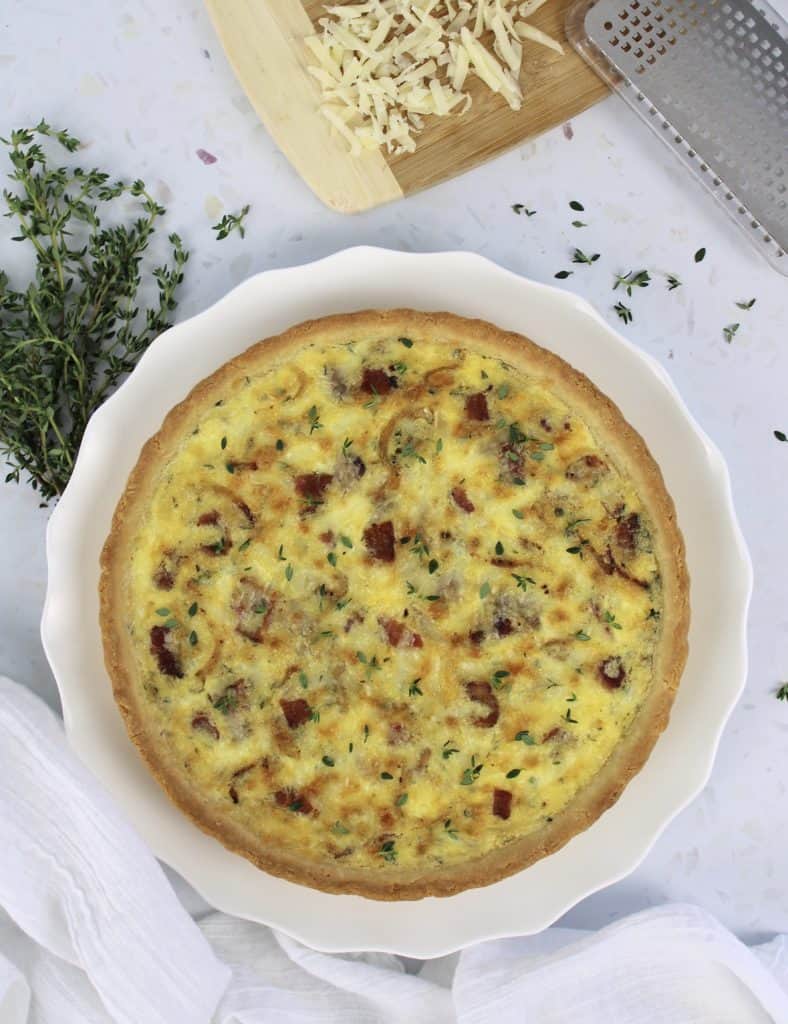 overhead view of quiche lorraine on white plate
