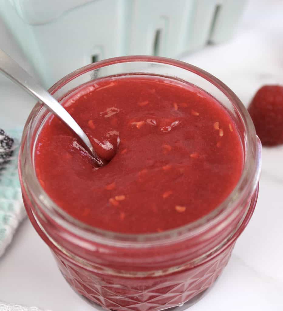 closeup of raspberry jam with spoon
