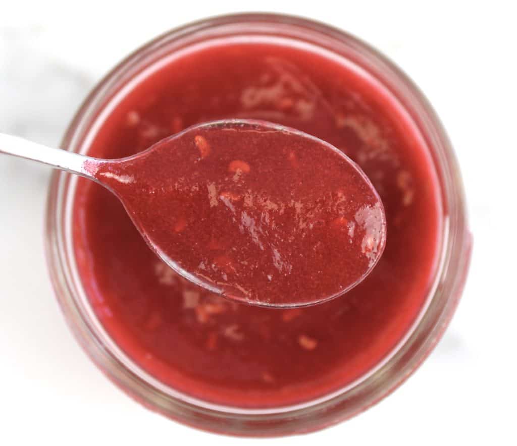 closeup of raspberry jam with spoon