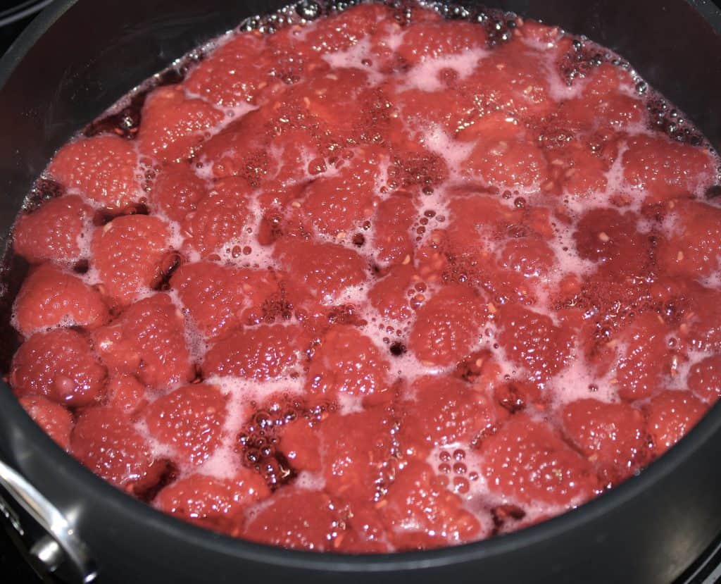 simmering raspberries in saucepan