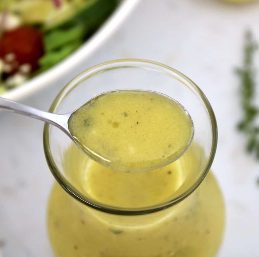 Lemon Vinaigrette in glass jar with spoonful