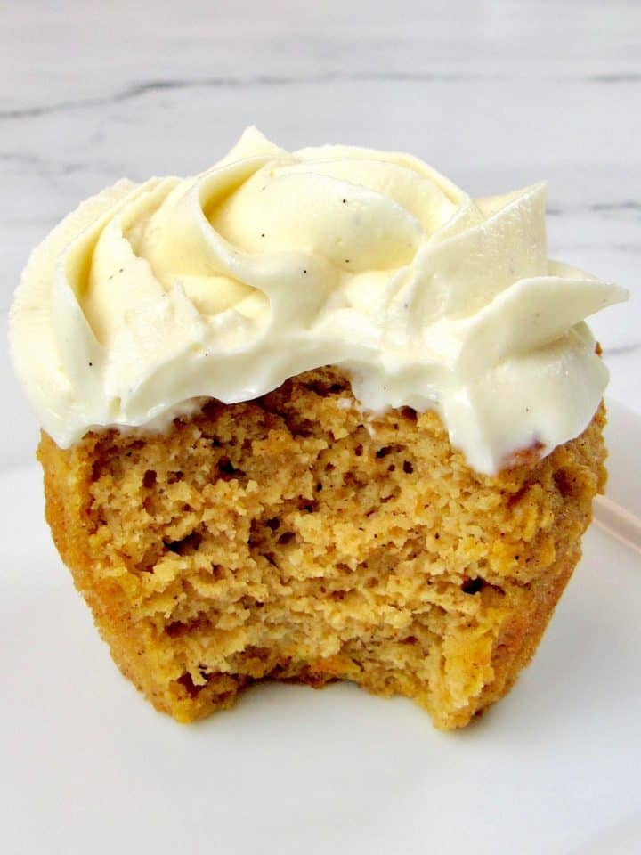 Pumpkin Cupcake with vanilla icing and bite missing