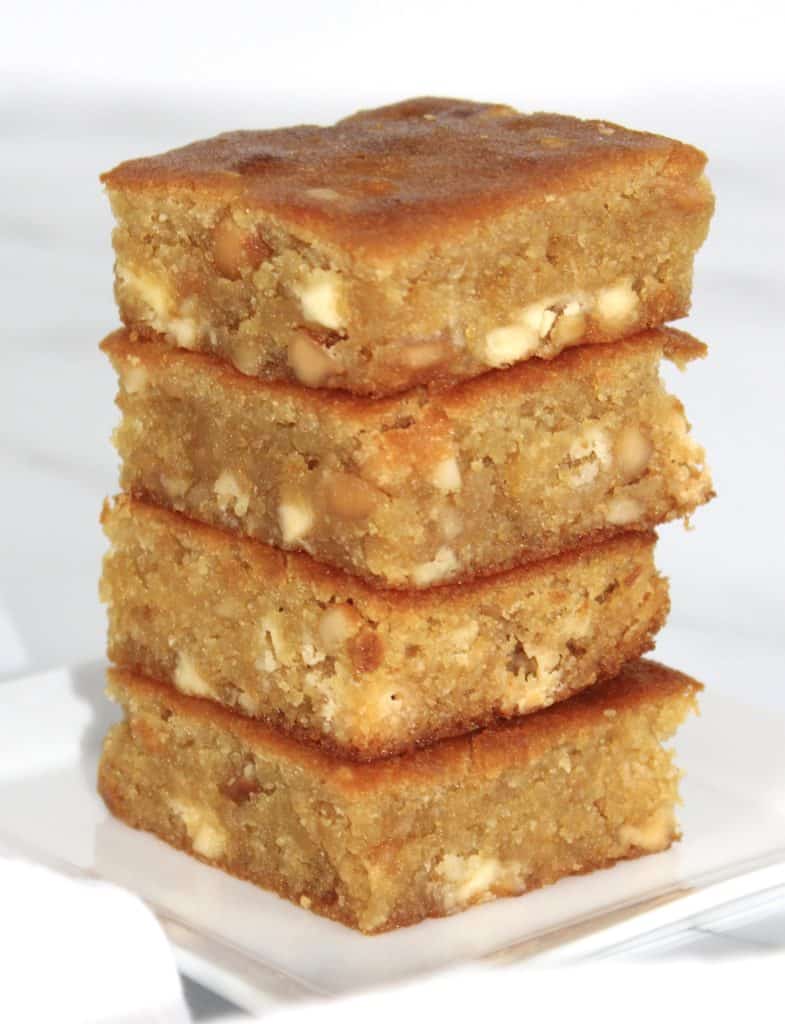 4 white chocolate blondies squares stacked up on white plate