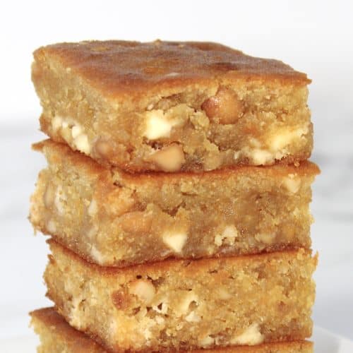 3 white chocolate blondies squares stacked up on white plate
