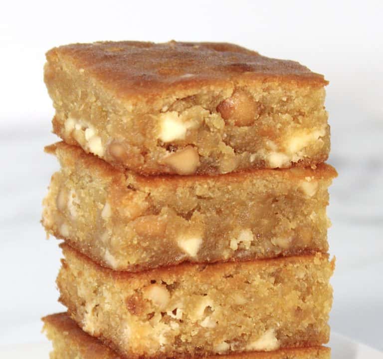 3 white chocolate blondies squares stacked up on white plate
