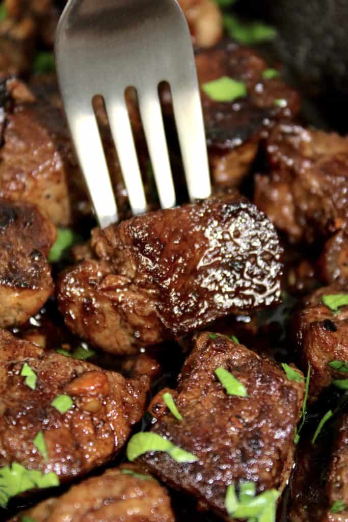 closeup of steak bites with fork in one