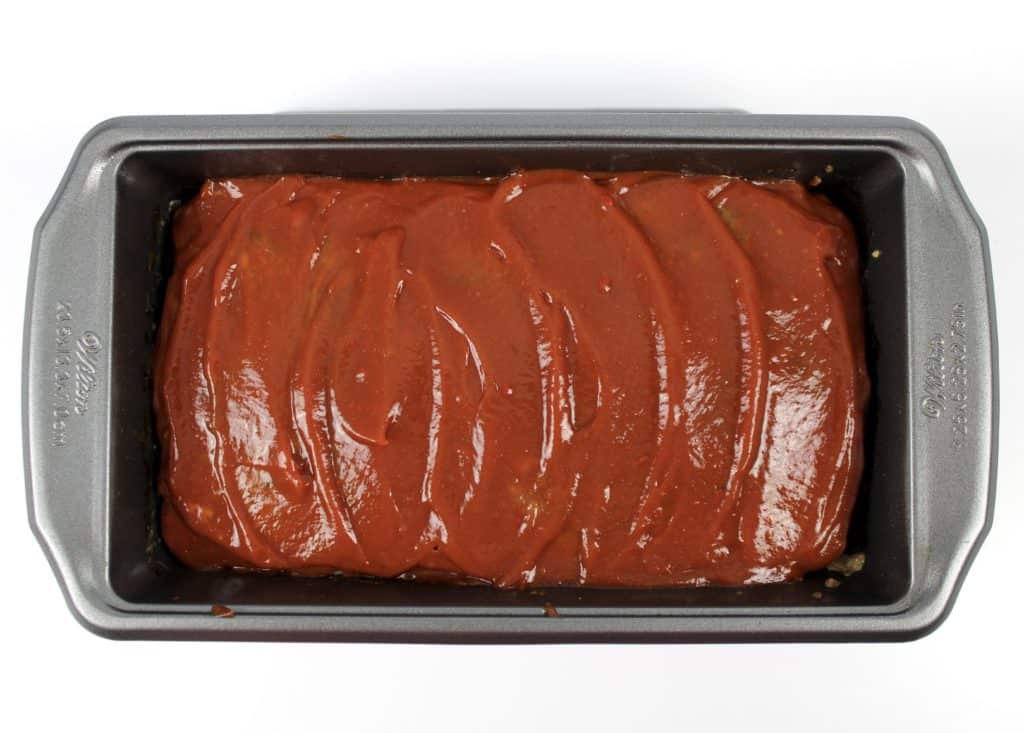 meatloaf in loaf pan with ketchup over the top