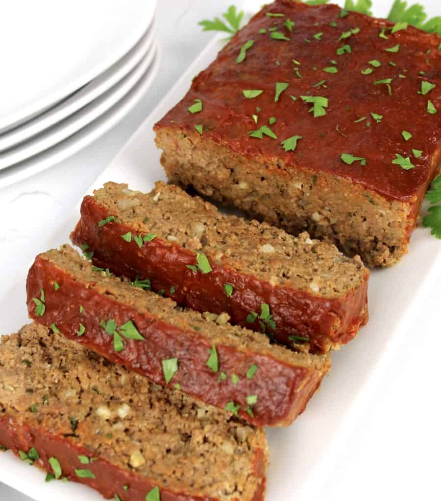 meatloaf on white platter with 3 slices