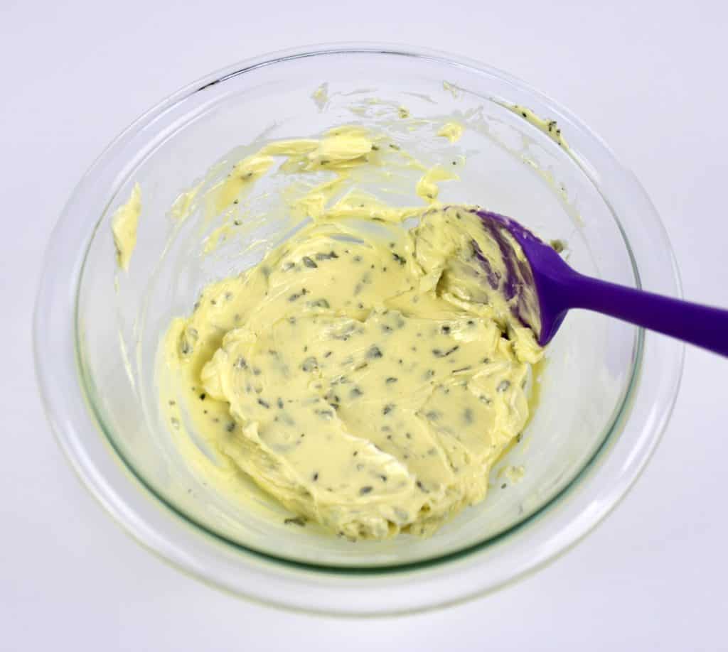 herbed butter in glass bowl with purpose spatula