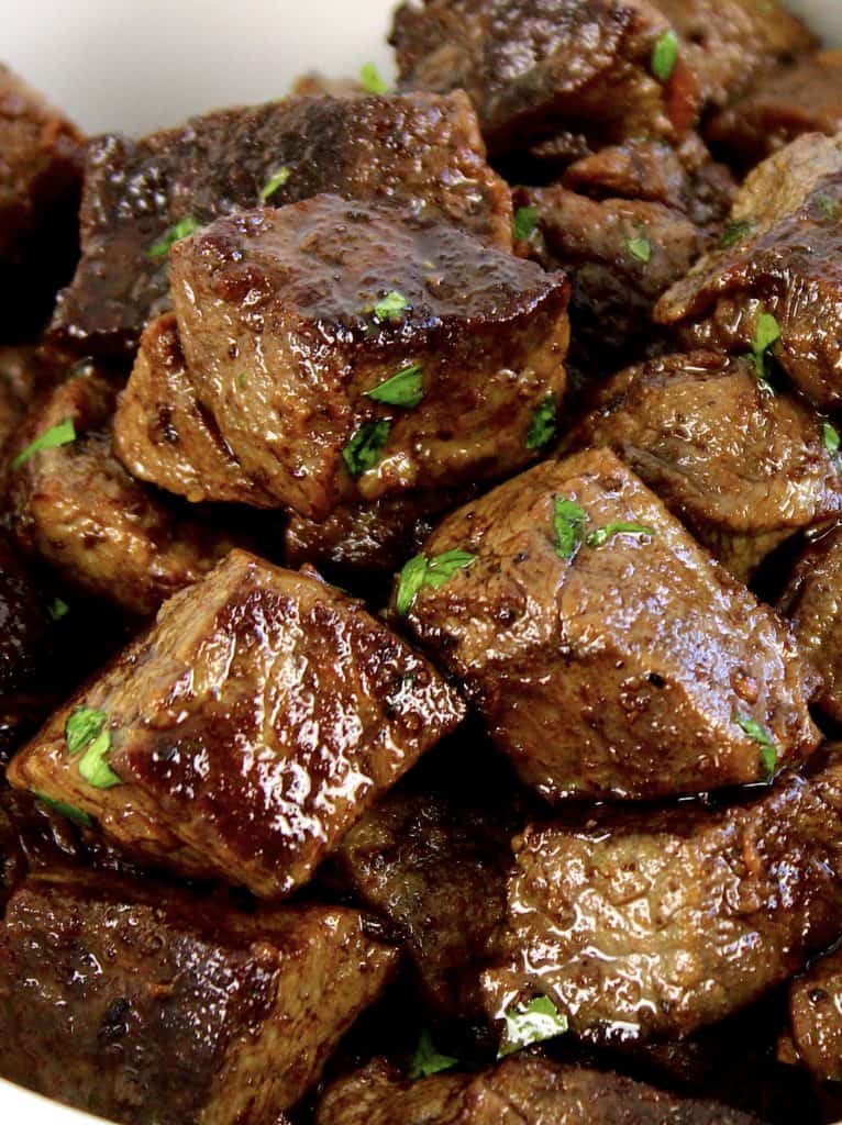 closeup of steak bites with parsley on top