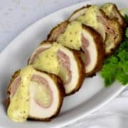 slices of chicken cordon bleu with mustard sauce on top
